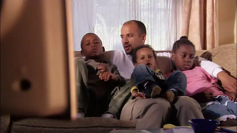 Canadian family watching TV with buffering icon