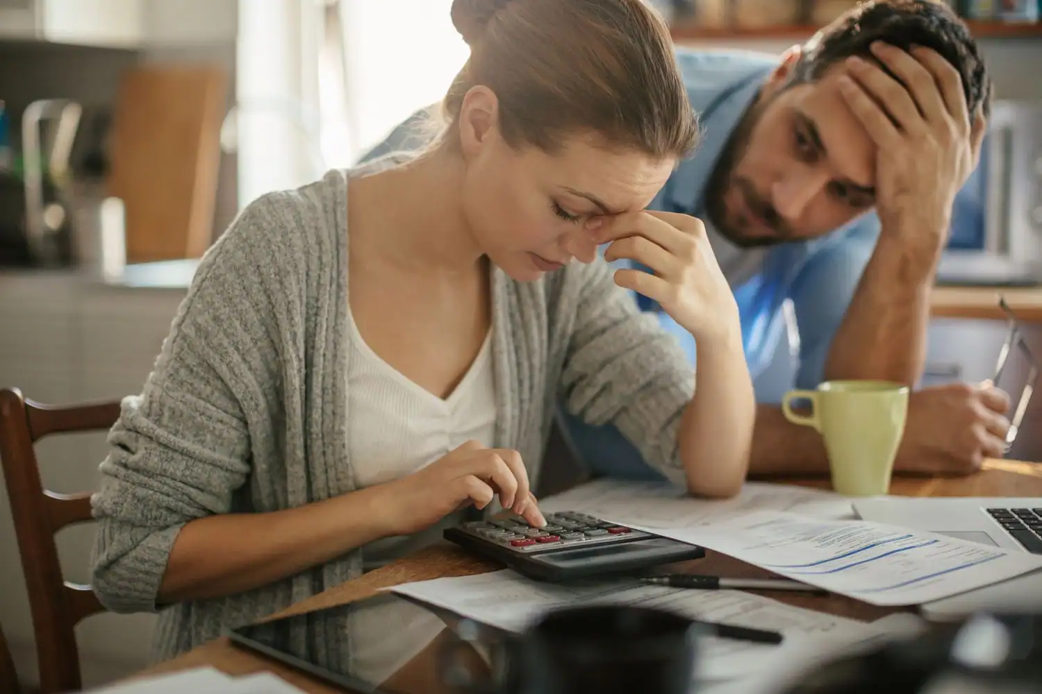 family comparing tv subscription bills at kitchen table