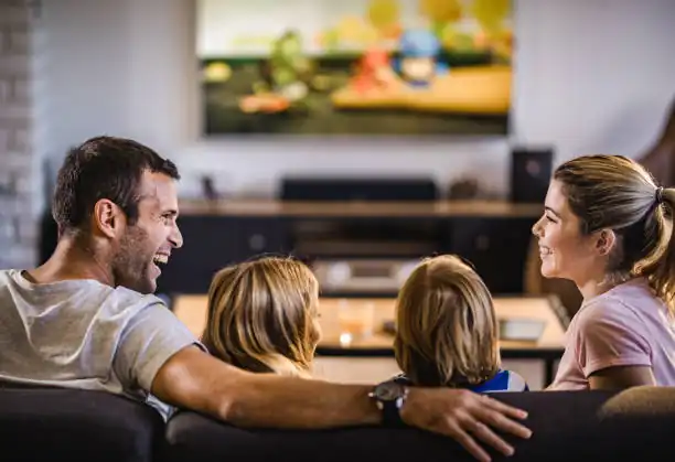 happy family watching streaming on smart tv